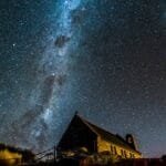 Captivating night sky with Milky Way over a historic church, ideal for astronomy enthusiasts.