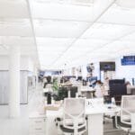 Spacious and well-lit office interior with modern furniture and workstations, ideal for a dynamic work environment.