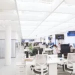 Spacious and well-lit office interior with modern furniture and workstations, ideal for a dynamic work environment.
