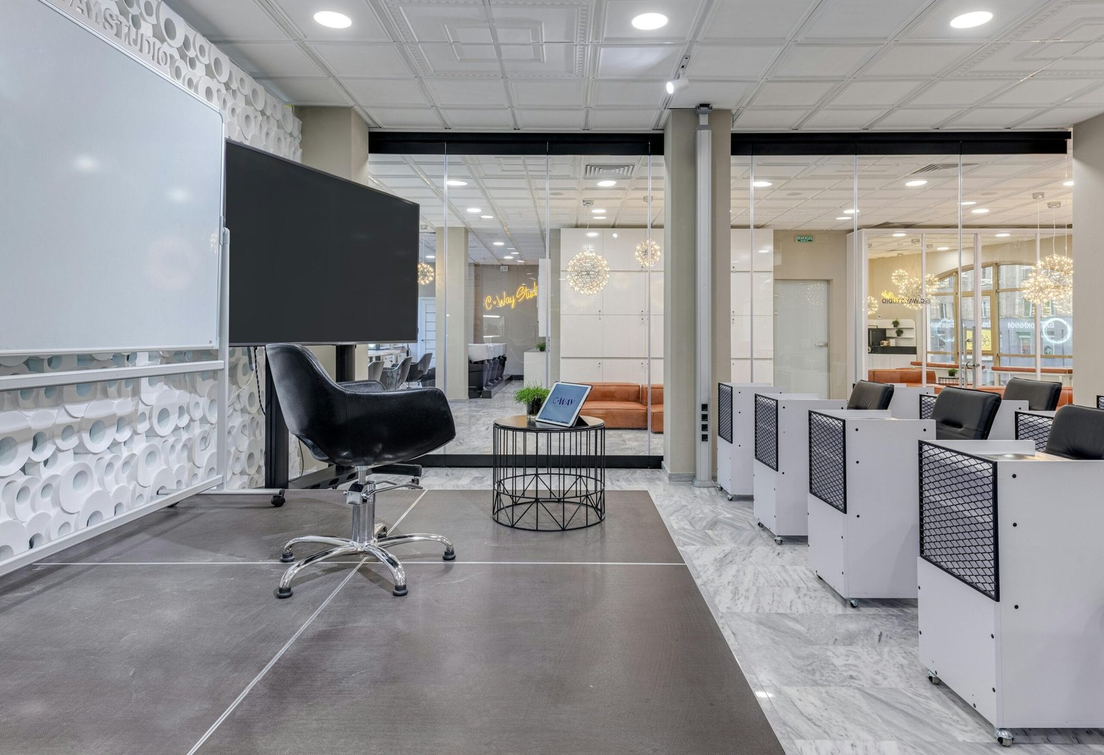A contemporary conference room with chairs, screens, and presentation boards.