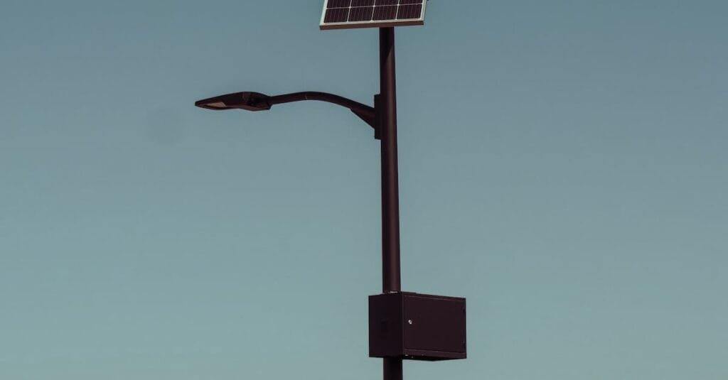 A solar-powered street light stands tall against a clear blue sky, symbolizing renewable energy.