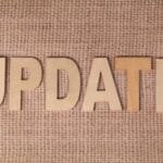 Wooden letters arranged to spell 'UPDATE' on a textured burlap surface, perfect for business or project imagery.