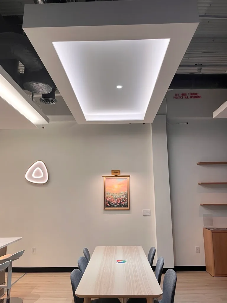 Kitchen zone — luminous panels and cove uplight on floating ceiling clouds